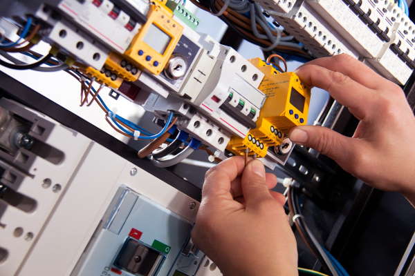Electrician working on control cabinet